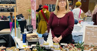 A woman poses with her products.