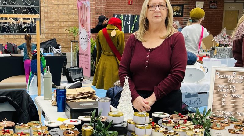 A woman poses with her products.