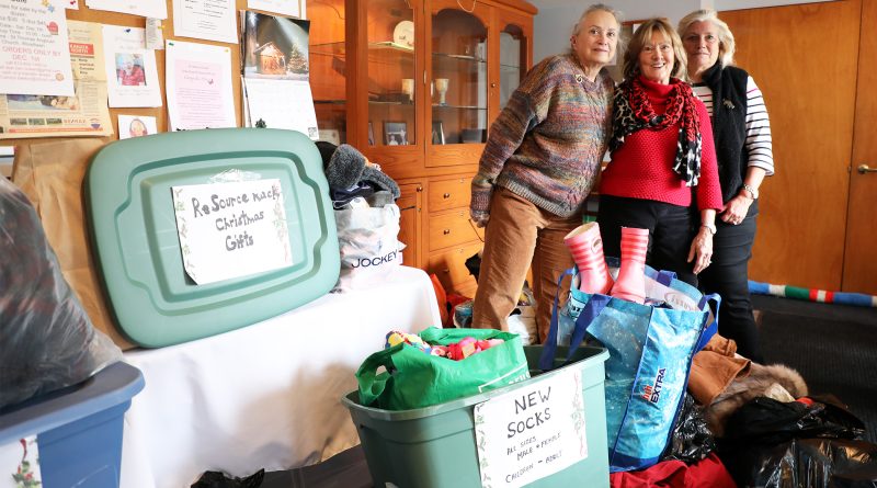 Three people pose with a huge donation.