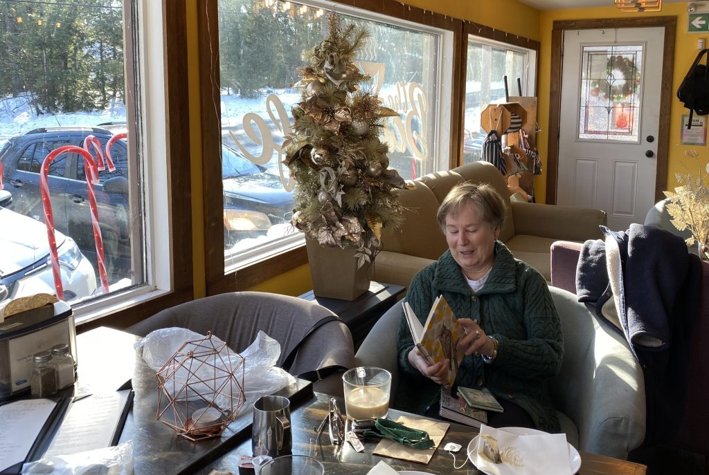 A woman looks at a journal.