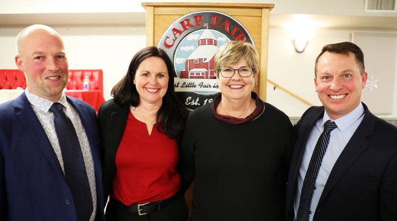 Four people pose for a photo.