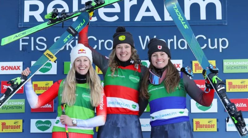 Three skiers celebrate on the podium.