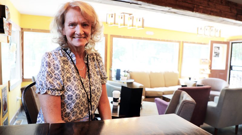 A woman poses in a cafe.