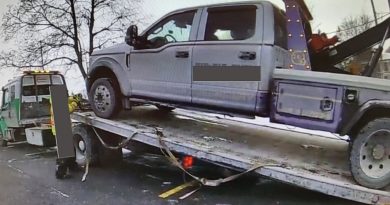 A photo of a tow truck being towed.