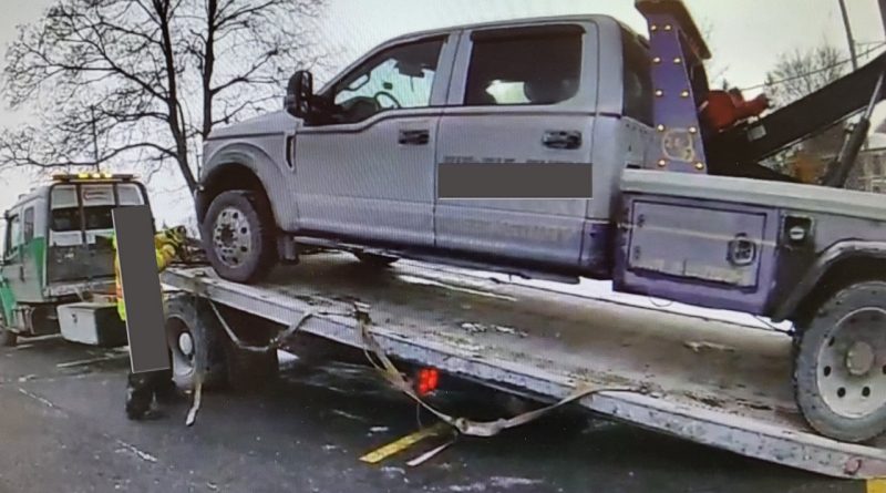 A photo of a tow truck being towed.