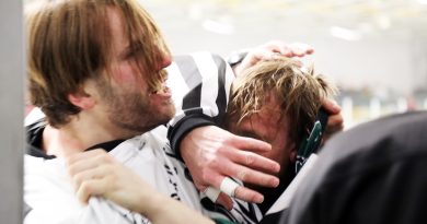 Two people fighting during a hockey game.