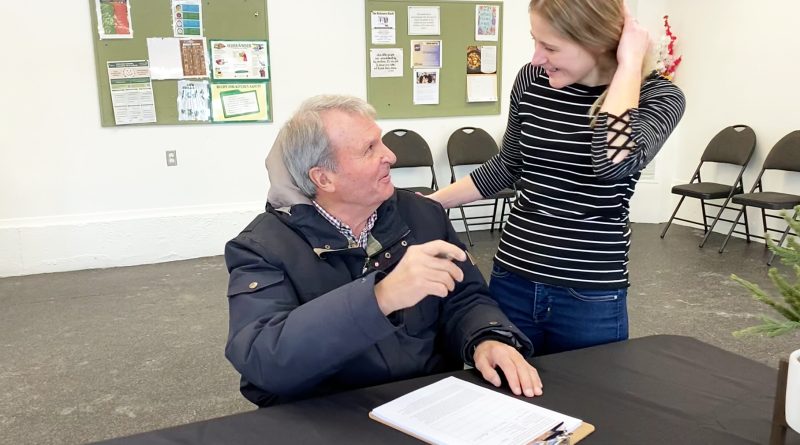 Two people sign a petition.