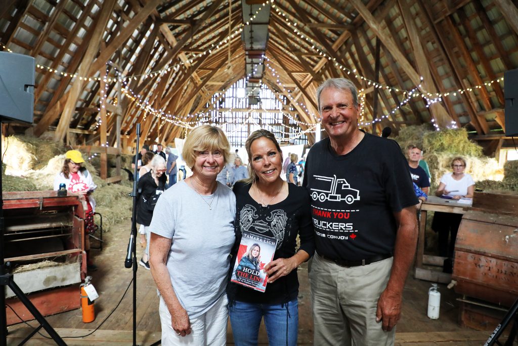 Three people pose for a photo,