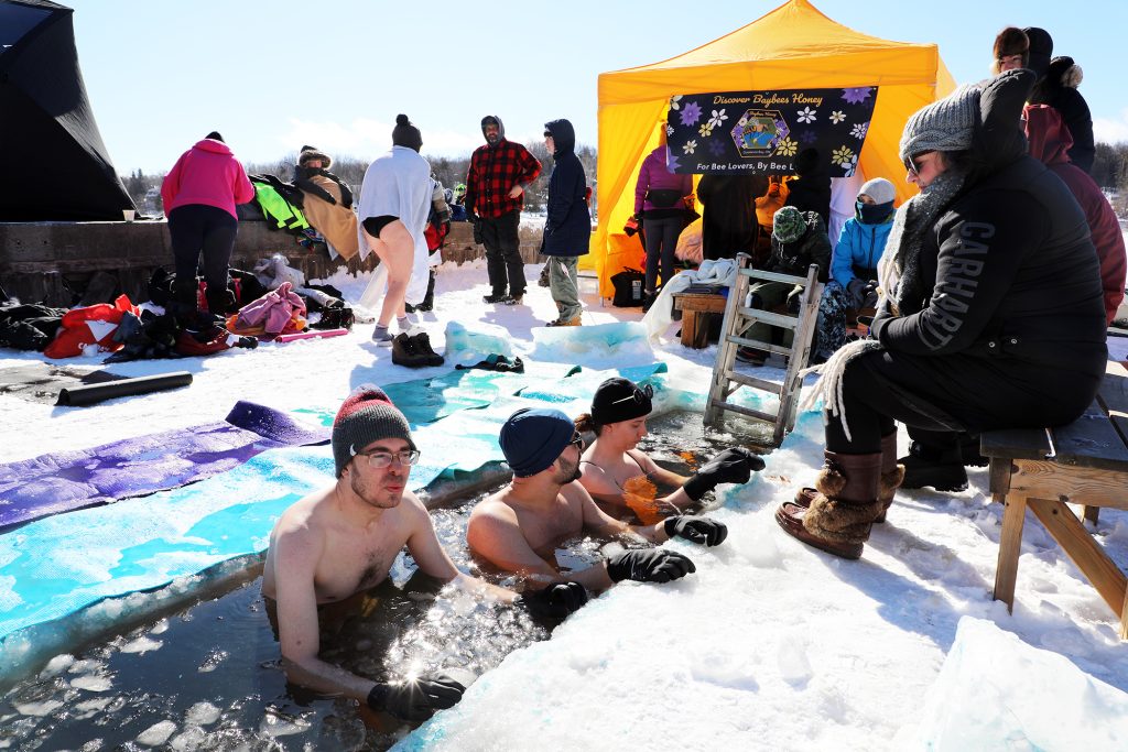 People take a dip in the freezing Ottawa River.