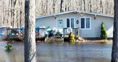 A photo of a house half submerged under water.