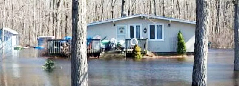 A photo of a house half submerged under water.