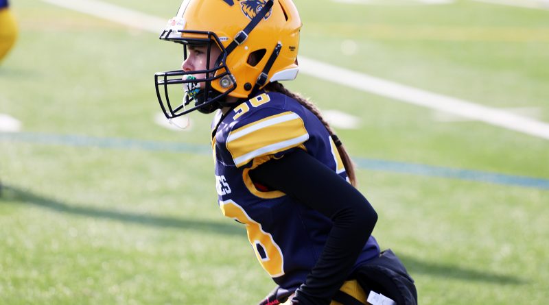 A football player gets ready to go.