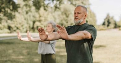 Two people perform Tai Chi.