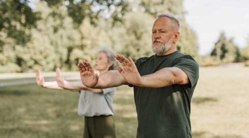 Two people perform Tai Chi.