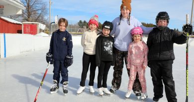 Six kids pose for a photo on the Carp rink.