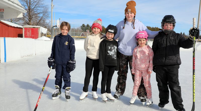 Six kids pose for a photo on the Carp rink.