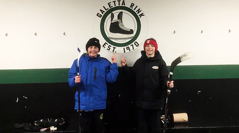 Two boys pose in the Galetta rinks changing room.