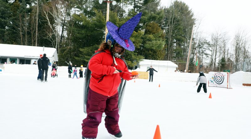 A witch skates with an egg on a spoon.