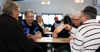 Four people play cards.