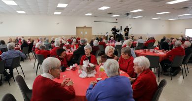A room full of people enjoy a luncheon.
