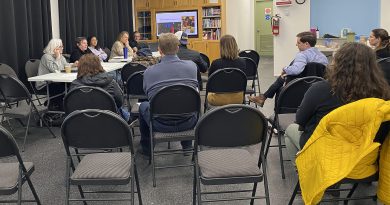 People sit at a meeting.