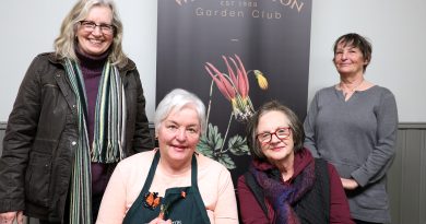 Four gardeners pose for a photo.