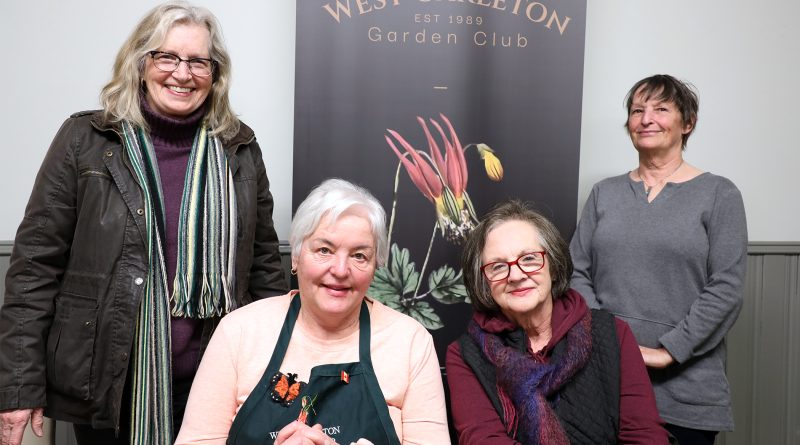 Four gardeners pose for a photo.