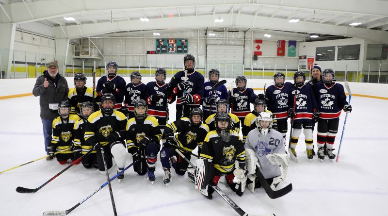 A group photo of two hockey teams.