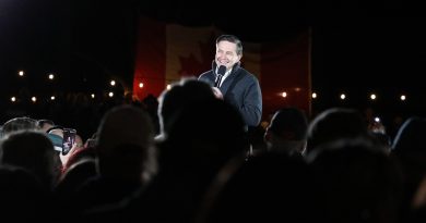 A man speaks to a large crowd.