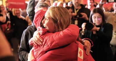 Two women hug after an election victory.