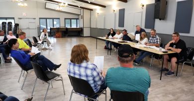 People listen in at a meeting.