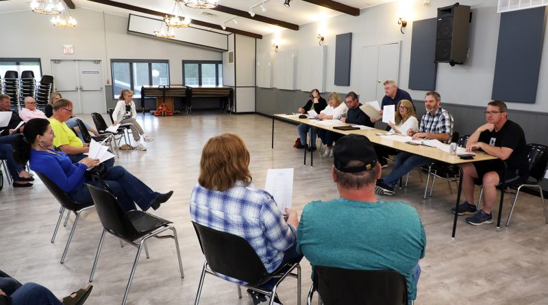 People listen in at a meeting.