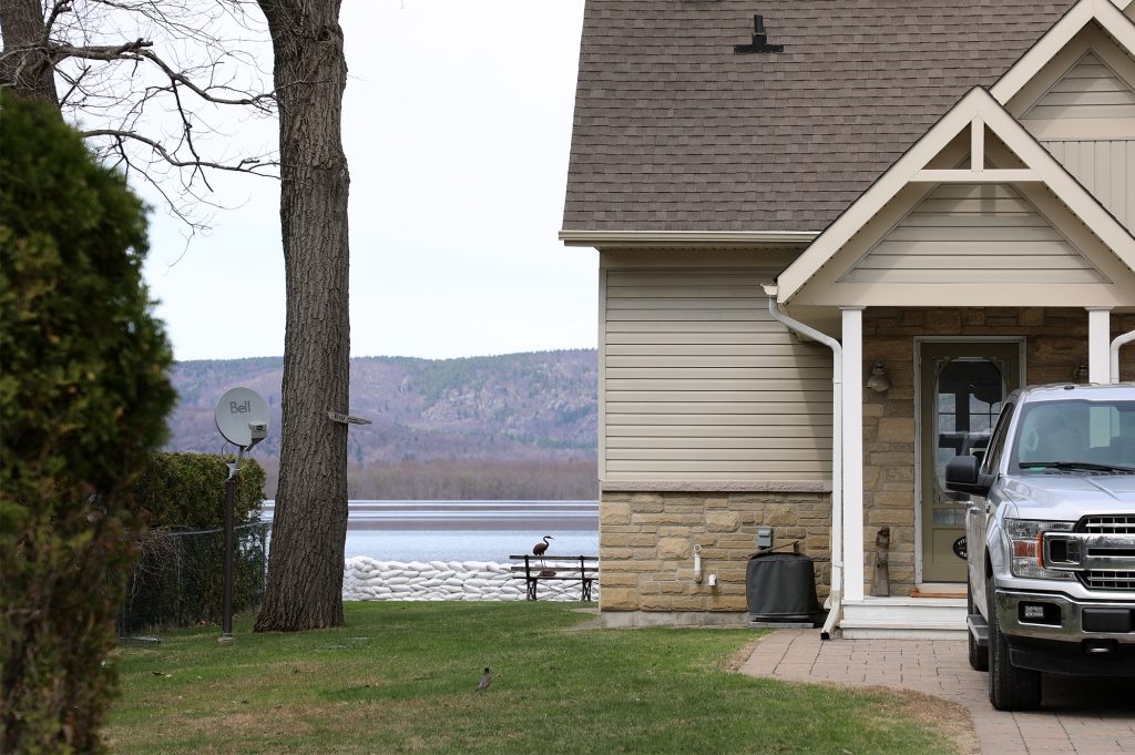 A sandbag wall sits behind a house.