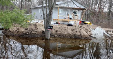A house sits surrounded by water.