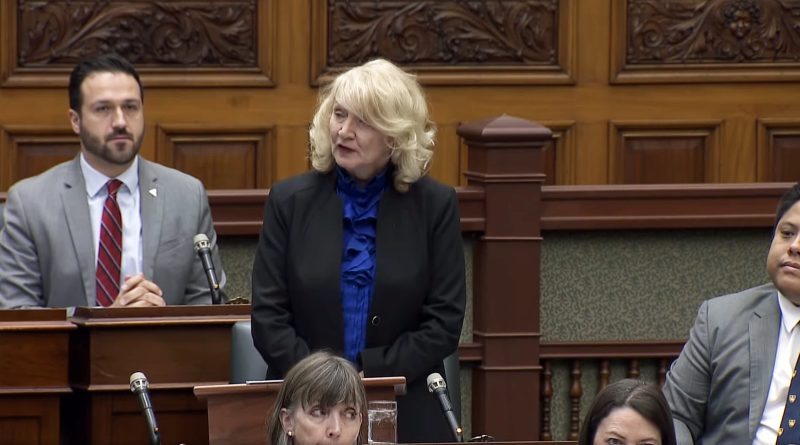 A woman speaks in Queen's Park.