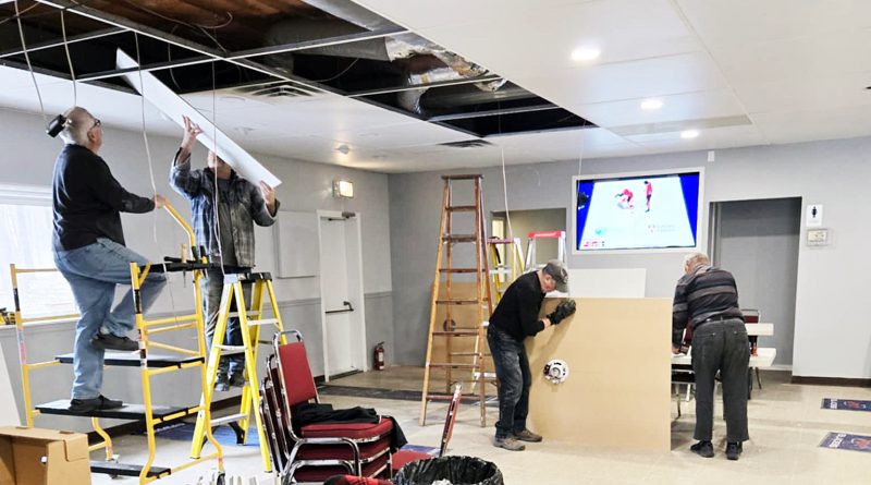 A photo of people renovating a room.