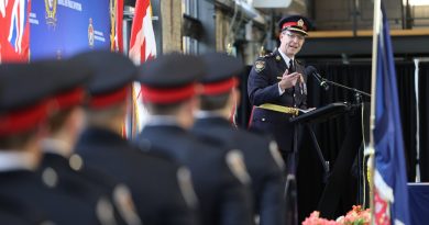 A photo of a police officer talking to new recruits.
