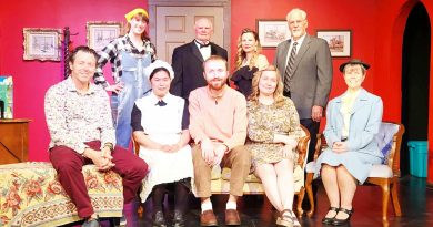 A cast poses for a photo.