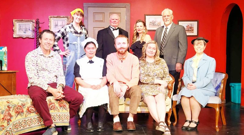 A cast poses for a photo.