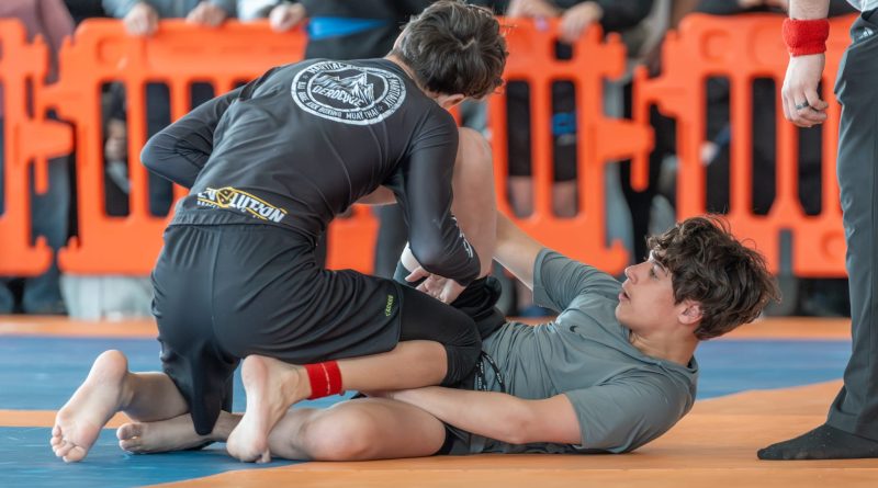 Two people battle it out in Jiu-Jitsu.
