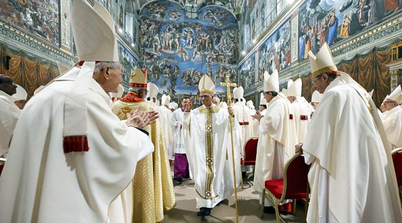 The pope is surrounded by colleagues during his first mass.