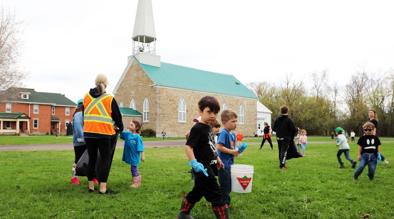 A photo of kids picking up trash.