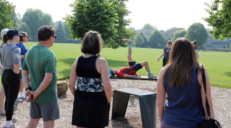 A person does excercises on a bench.