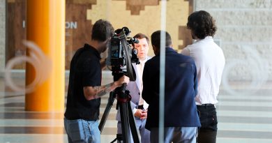 A person is interviewed by the press.