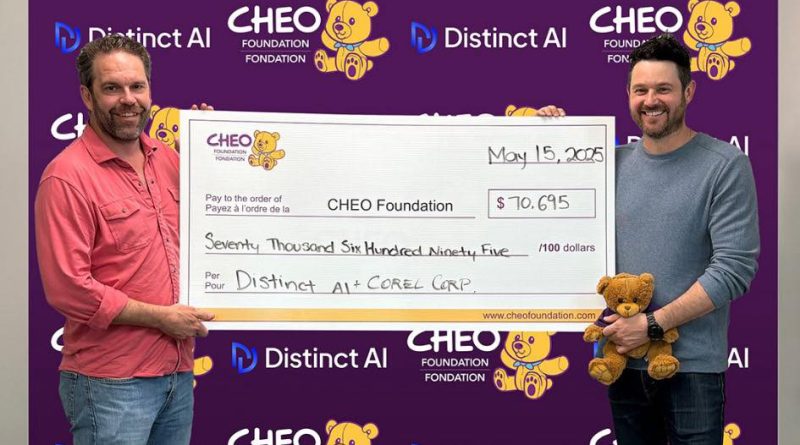 Two people hold a really big cheque.