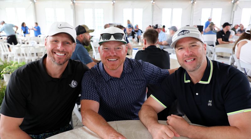 Three hockey players pose for a photo.