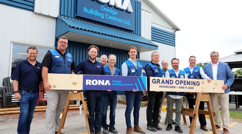 A group of people pose in front of a RONA store.