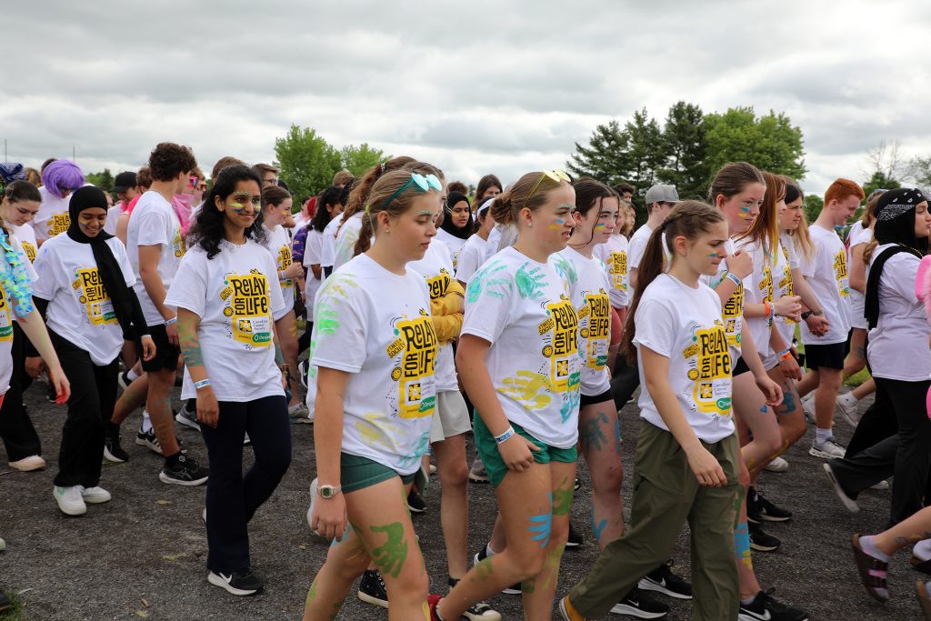 A large group of students walk.