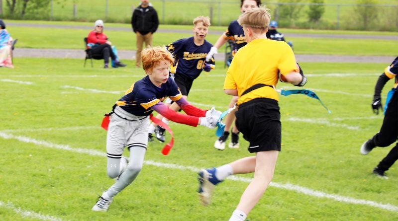 A photo of people playing flag football.