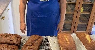 A woman poses in front of lemon loaf.